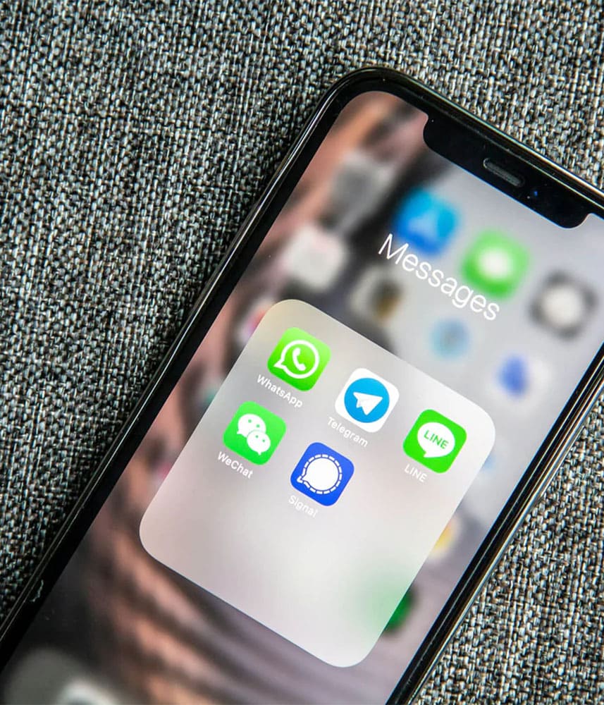 Applications de messagerie sur téléphone sur tissu gris.
